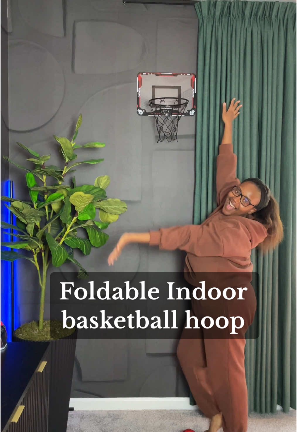 A post by @myuglyapartment on TikTok caption: This hoop is in my bio under “shop this man cave” #indoorbasketballhoop #mancavedecor #sportsdecor #masculinedecorinspo #apartmentdecorideas #masculinedecor #masculinedecorating #apartmentdecor #cozyapartment #atlantainteriordesigner 