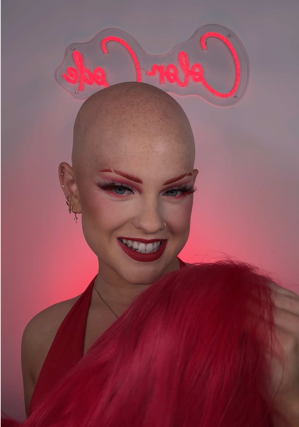A post by @ on TikTok caption: Do you guys like my new Color Code sign🥹 WHO WANTS TO SEE PART 2?? Should I post it today?❤️  The makeup:  -for brows I am using the L’Oreal Faux brow, @L’Oréal Paris and then I went in with a liquid red eyeliner  -for my eyeshadow im using the red shade from the Colourpop Toy Story palette and the Stranger Things Palette @ColourPop Cosmetics  -for my black eyeliner im using the liquid liner by One Size @ONE SIZE BEAUTY  -my lashes are the Miami Lashes by Lilly Lashes and the individual red lashes are also by Lilly Lashes @Lilly Lashes  -my foundation is the Turn Up the Base full beat by One Size  -for the powder I am using the One Size foundation powder   -for lips im using the Nars red lipstick @NARS Cosmetics  -for setting im using the one by L’Oreal Paris  My hair: -my wig is from @Zee.elle  #cppartner #makeup #alopecia #wigs #makeuptutorial #redmakeup #red 