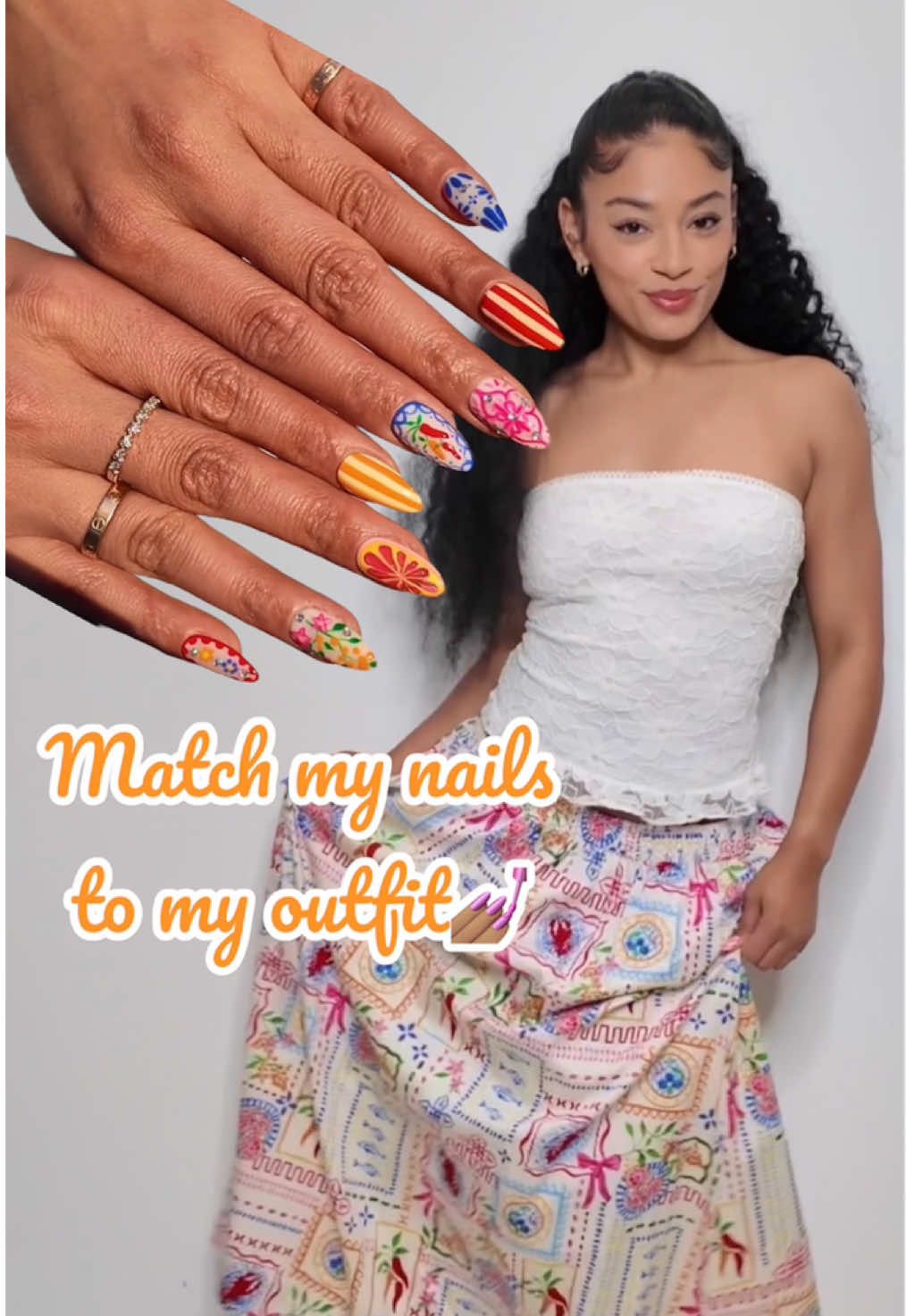 A post by @jasmeanbrown on TikTok caption: Found the perfect outfit at @Marshalls for my birthday trip! This cute lace tube top & the star of the show, this patterned skirt!🤩 It inspired me to make a matching set of nails to go with it! 💅🏽✨Any guesses on where I’m going based off the outfit & nails?! #ad #mbassador 