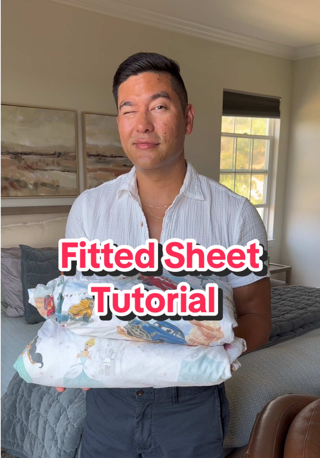 A post by @athomewithbryan on TikTok caption: More than 300 of you requested a tutorial on how to fold that stubborn fitted sheet. You got this! #tutorial #fittedsheet #hgtv #howto #athomewithbryan 