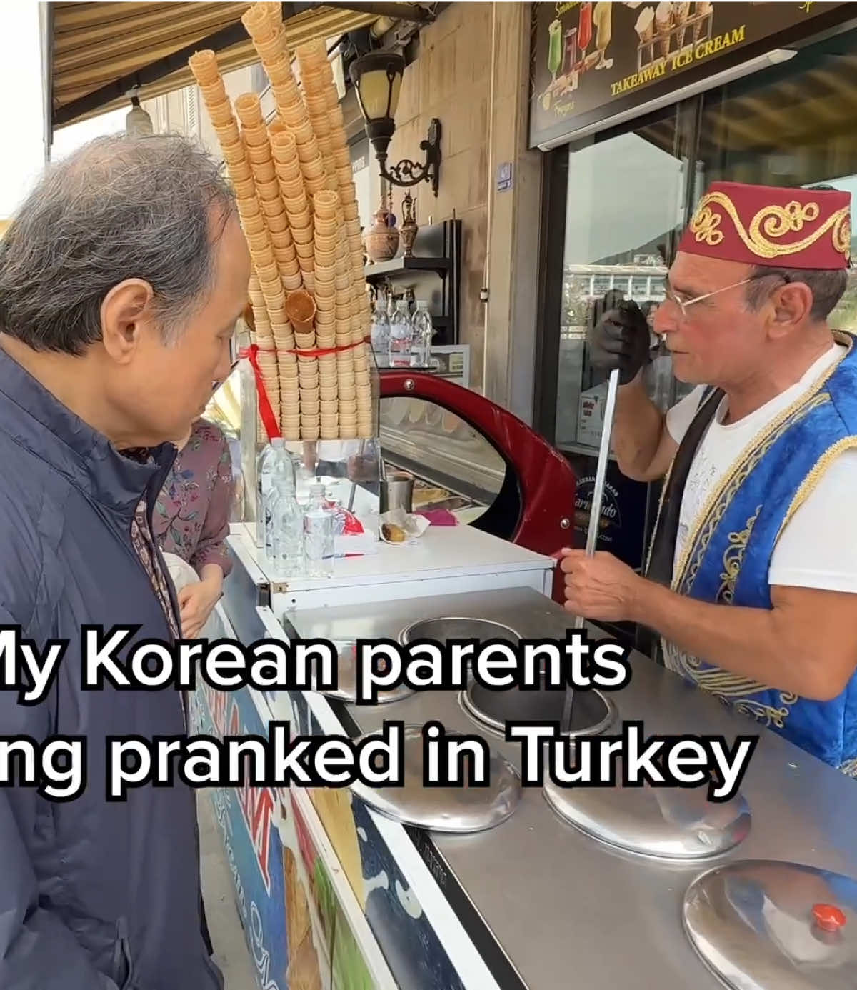 A post by @crazykoreancooking on TikTok caption: When we were passing by the ice cream vendor in Ephesus, Turkey, no one was getting ice cream. So dad had no idea what he was getting into. He was very happy about the idea of getting ice cream as usual. He doesn’t get angry very easily but he was deeply annoyed by this one. Sorry, dad. 😛