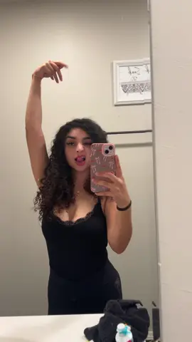A post by @ on TikTok caption: 🖤🖤 #fypシ #curlygirly #feelingirl #feelingirlbodysuit 