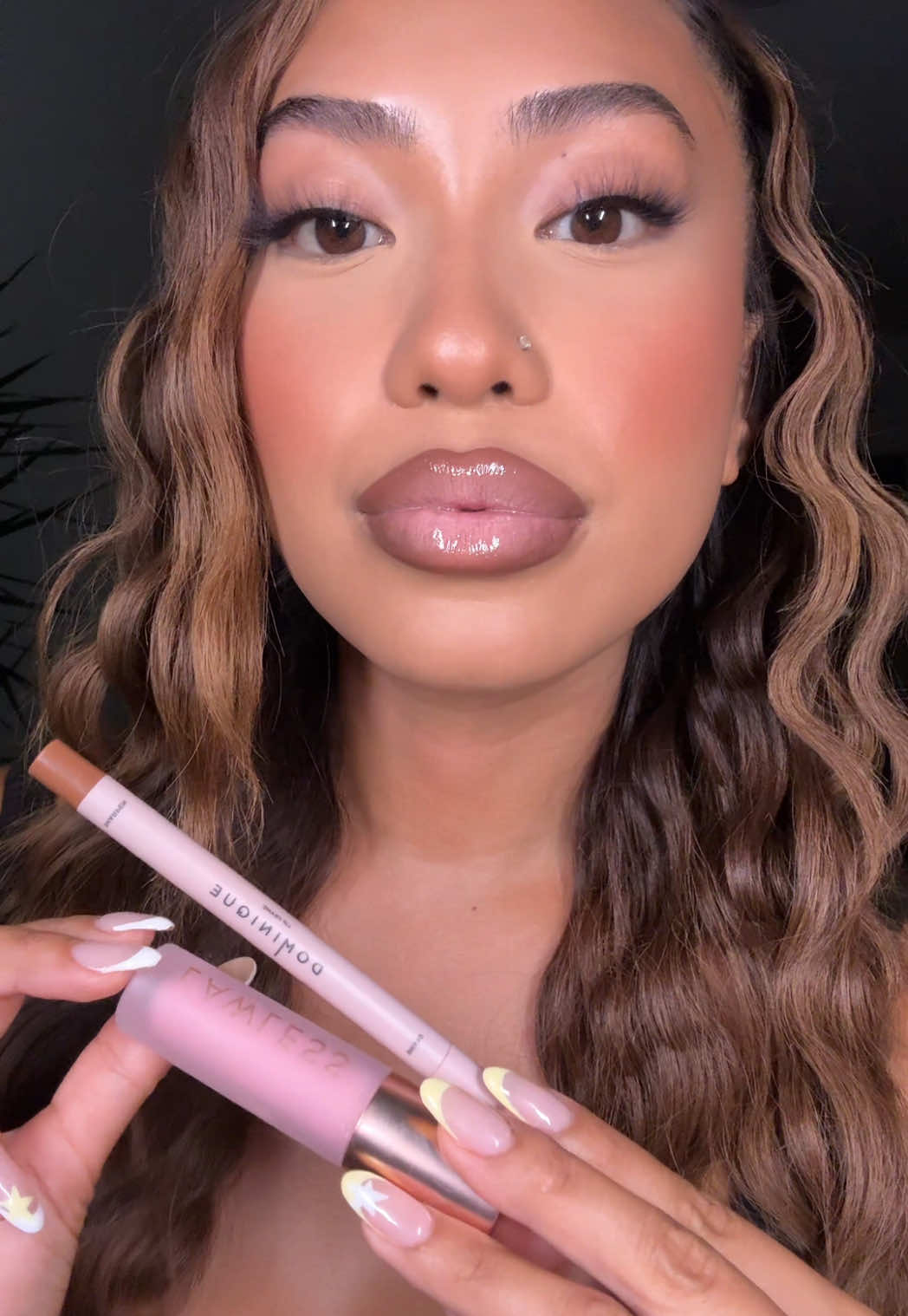 A post by @imabbysigua on TikTok caption: 👄 my current go-to lip combo  Products: Dominique cosmetics in hot chocolate + lawless strawberry milkshake 