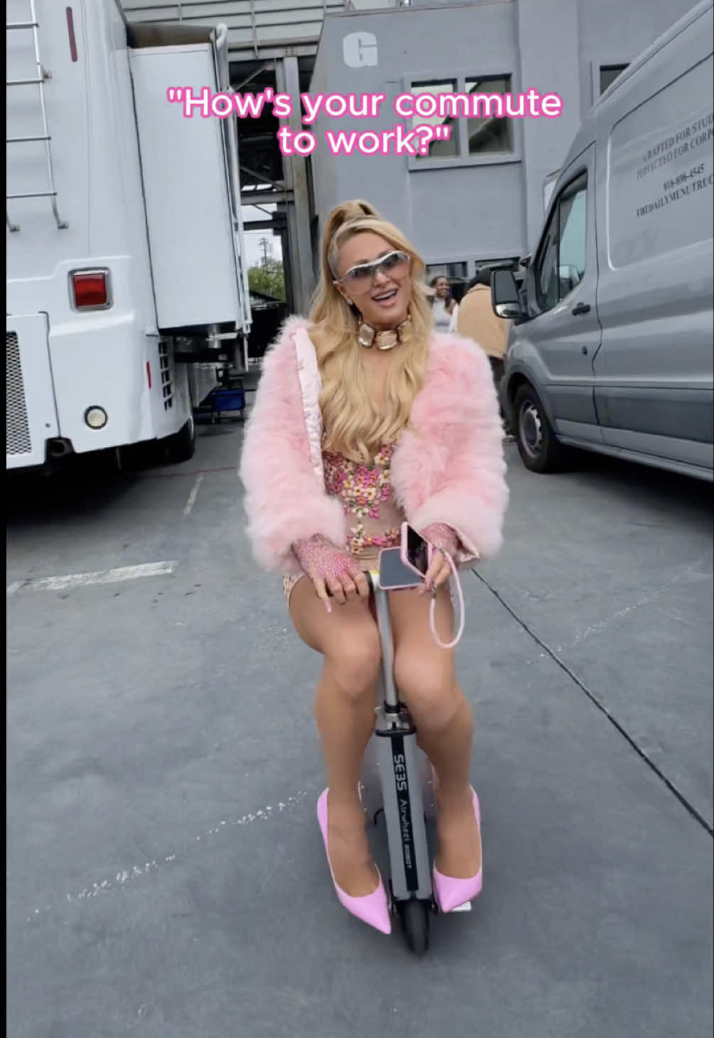 A post by @parishilton on TikTok caption: More like commute to #Werk 😂💕 Pulling up to the photoshoot in #Sliving style ✨