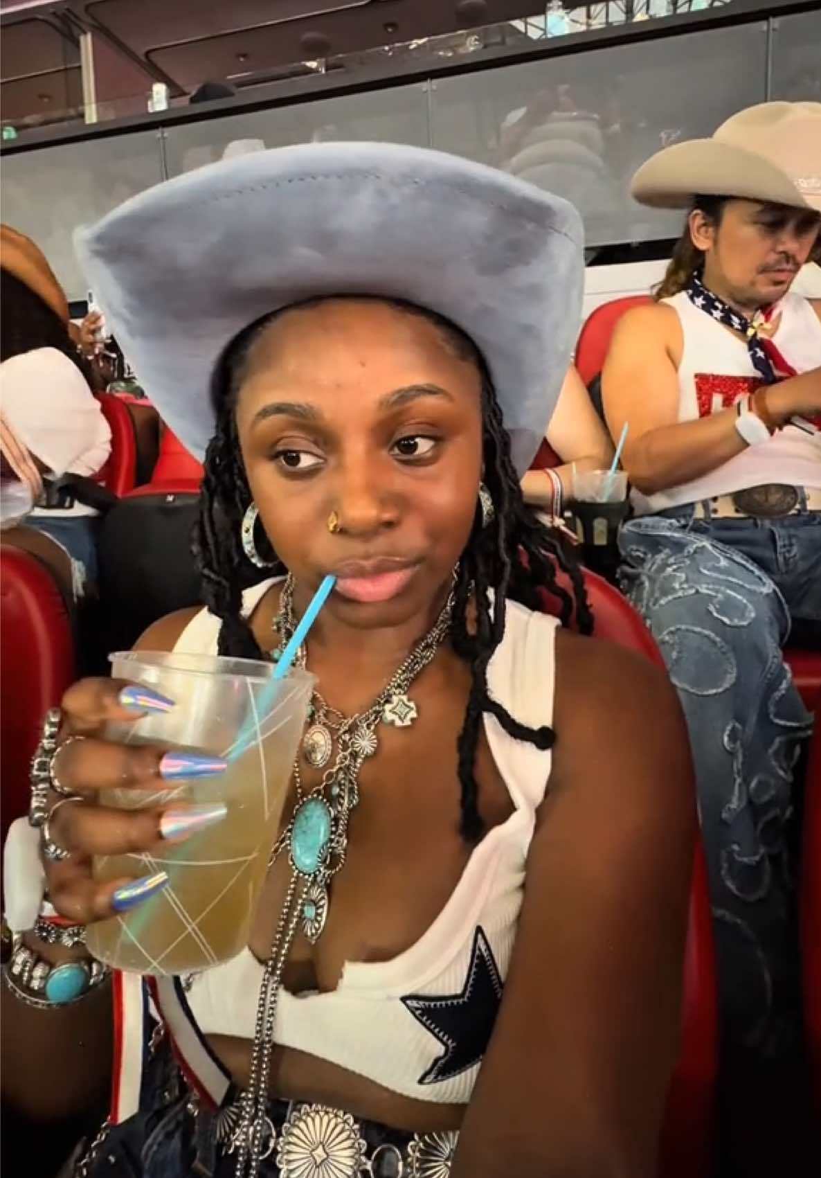 A post by @_alizej on TikTok caption: @Beyoncé Cowboy Carter Atlanta Night 3 Concert Watchalong 🏇❤️‍🔥 @SirDavis …can I get a bottle!? 👀👀😭 Hat: @buckle  Jewelry: Boot Barn Shorts: @Revolve  Boots: @Free People  Top: @Hobby Lobby  #beyonce #cowboycarter 