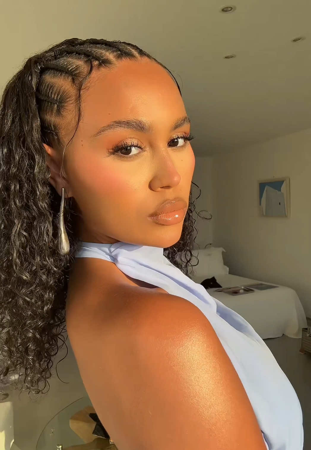 A post by @3llathomas on TikTok caption: Finishing touches in Ibiza 🩵 Products: @rabanne eye palette @Diorbeauty blush & lipglow butter 101 @maccosmetics liner cork @Fenty Beauty gloss bomb stix 02 @Vaseline guta hya @L'Oréal Paris UK infallible setting spray 
