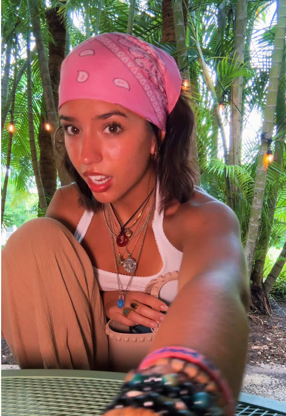 A post by @valeklinar on TikTok caption: The way this song rhymes scratches something in my brain 🧎‍♀️ #justagirl #thrifted #shorthair #bangs #jewelry 