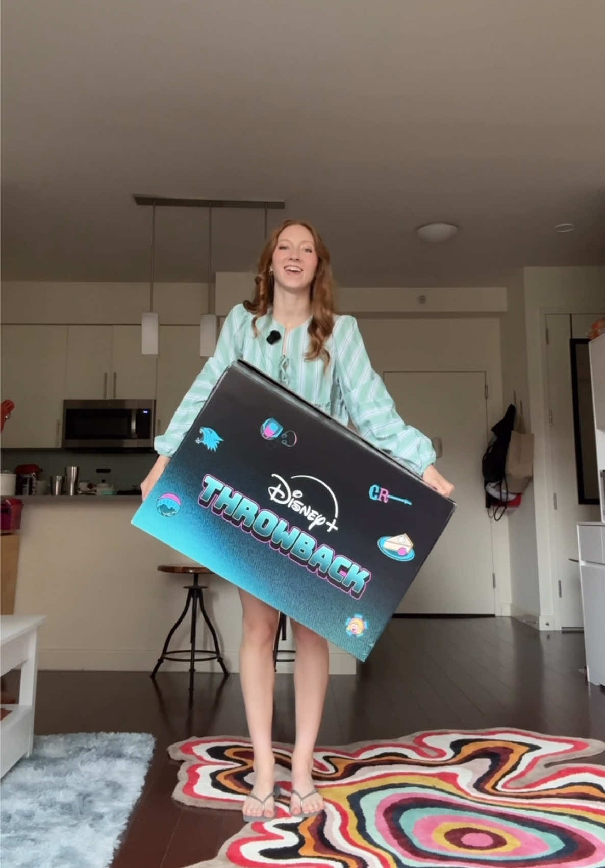 A post by @melissabecraft on TikTok caption: Mystery package from Disney. What should I keep in it? I’m thinking of putting my cats’ things inside 😂 @Disney+  #DisneyPlusThrowback  