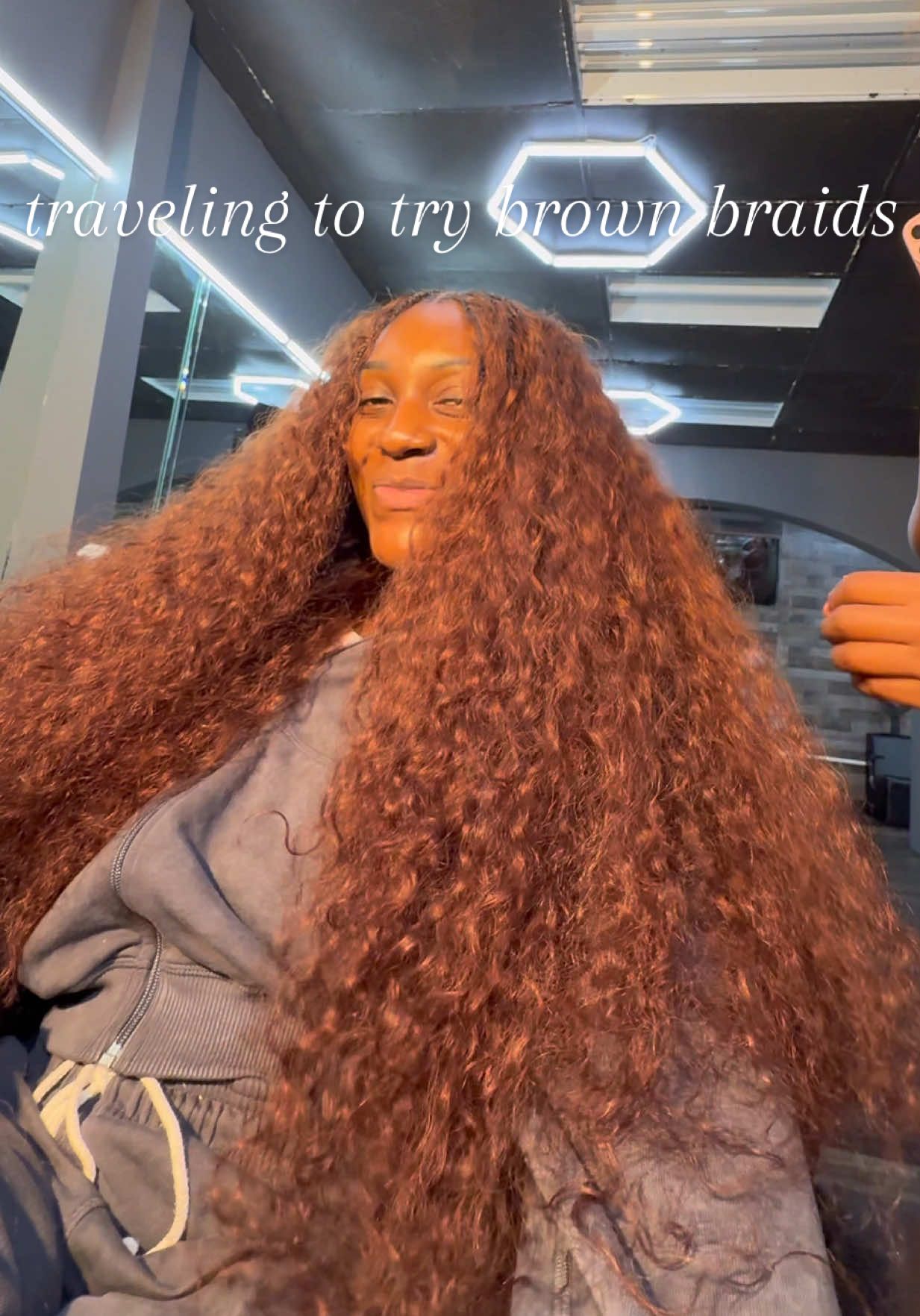 A post by @ on TikTok caption: The real question is do y’all think imma keep it in?👀 I will NEVER cheat on my braider… if I gotta catch a flight, book it #gettingbraids #redbraids #chocolatebrownbraids