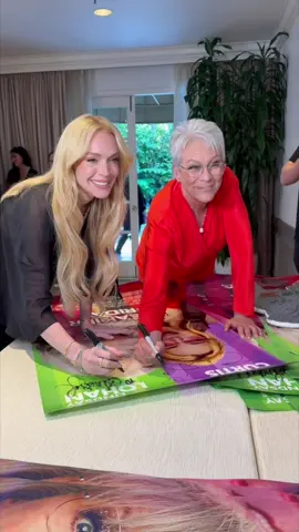 A post by @jamieleecurtis on TikTok caption: Signing #FreakierFriday posters with @lindsaylohan 💜💚 In theaters August 8, get your tickets!!