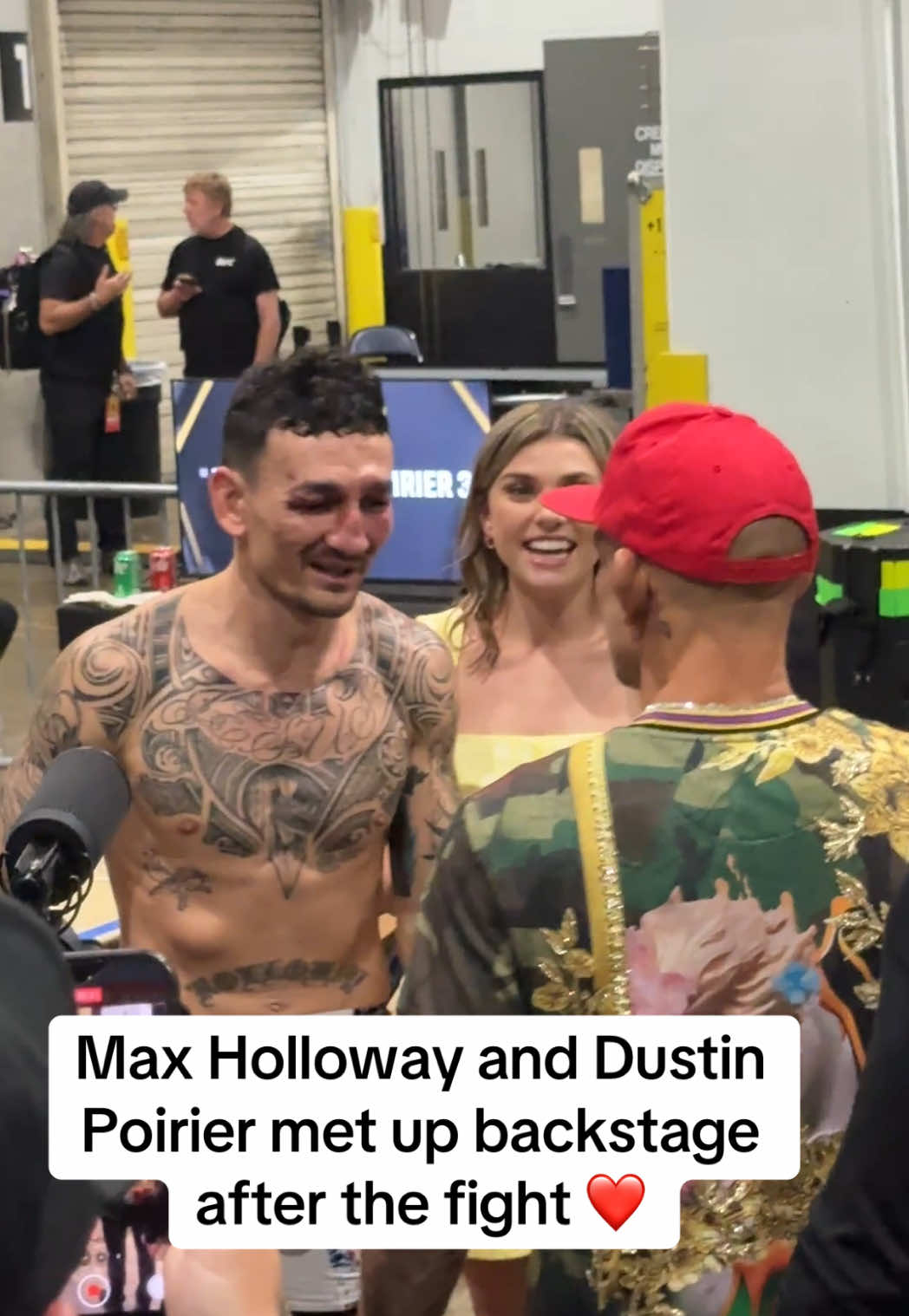 A post by @espnmma on TikTok caption: What a moment between these two 👏❤️ #dustinpoirier #maxholloway #UFC318 