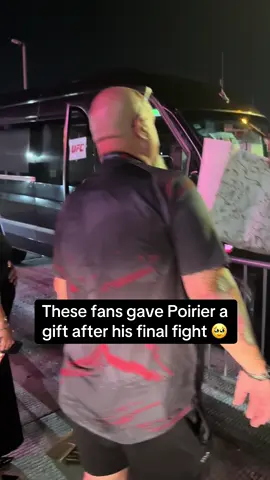 A post by @espnmma on TikTok caption: Look at what this gift means to Dustin Poirier #UFC #ufc318 #dustinpoirier 