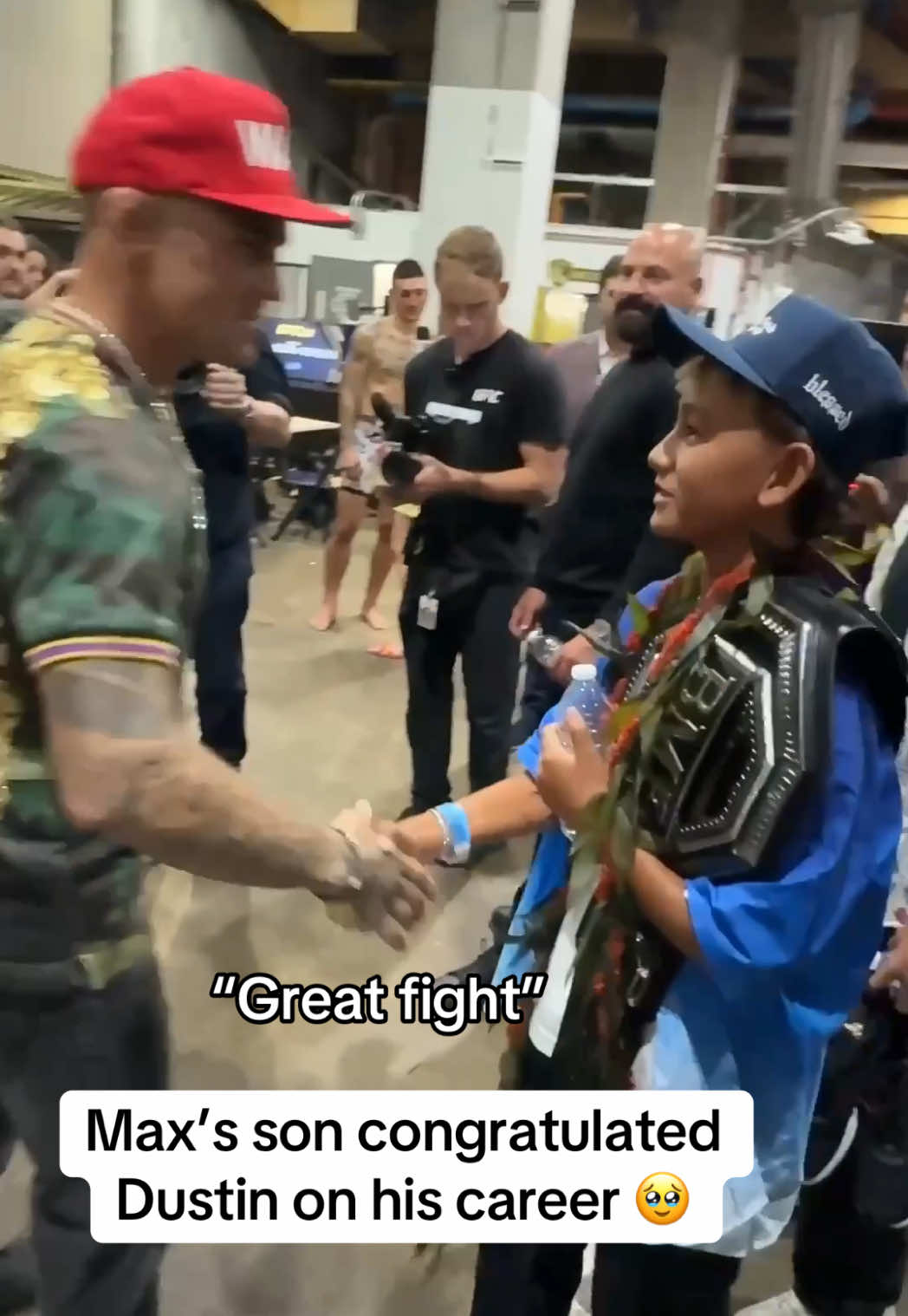 A post by @espnmma on TikTok caption: What a moment backstage between #MaxHolloway’s son and #DustinPoirier ❤️👏 #UFC318 #UFC #MMA