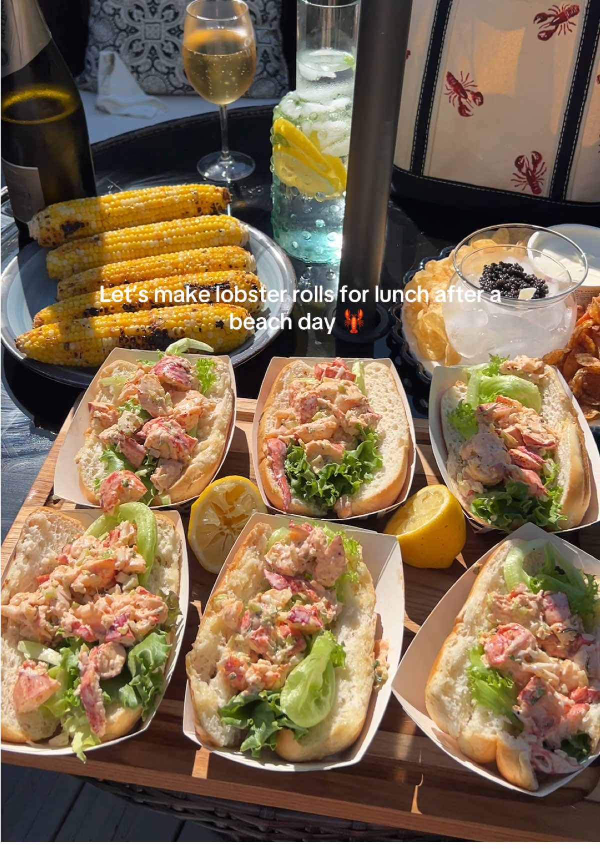 A post by @claudia.harrington on TikTok caption: Lobster rolls, corn, caviar, & cape cod chips … my dream date. #lobsterrolls #newenglandsummer #newengland #caviar #cornonthecob #capecod #falmouth 