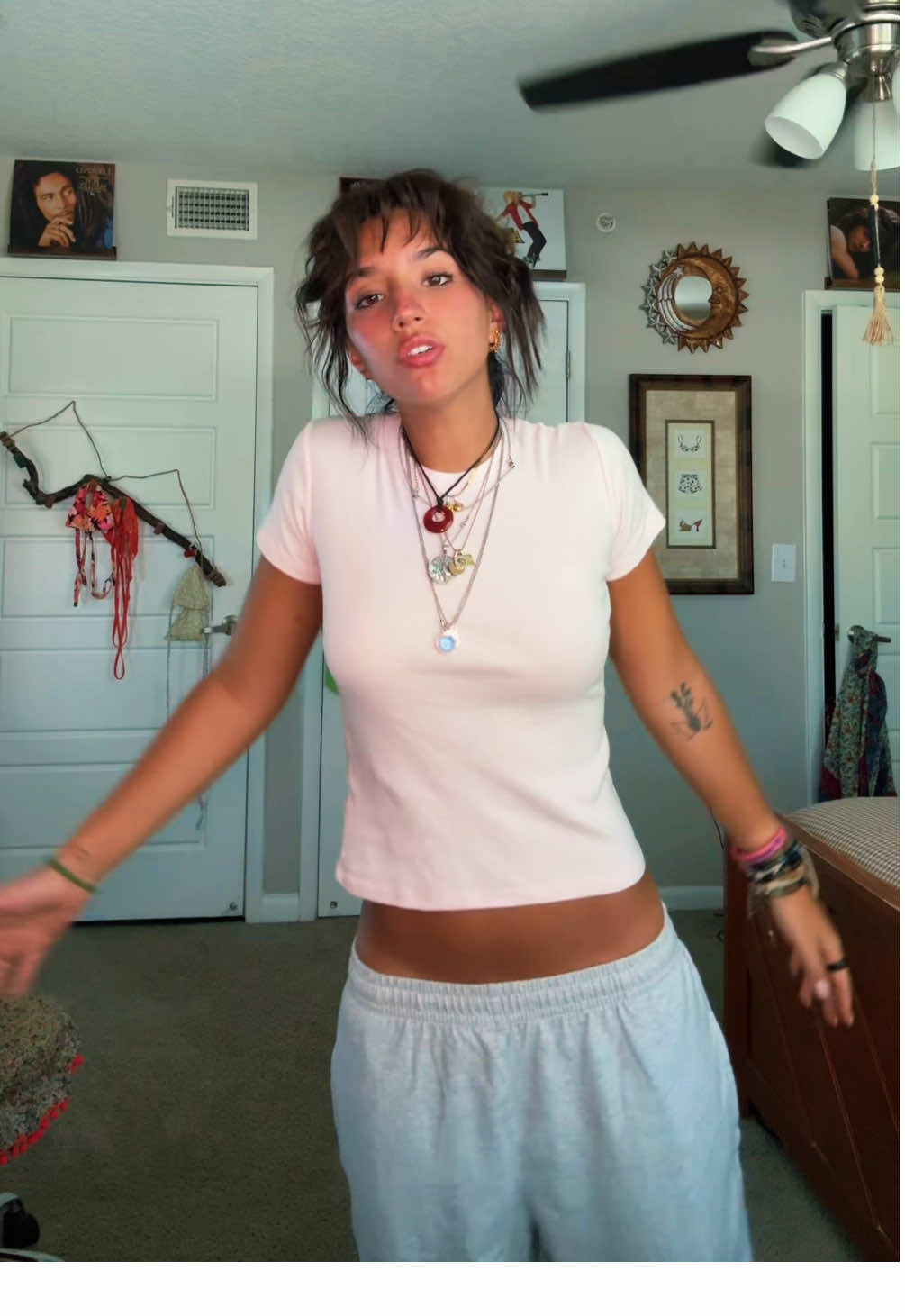 A post by @valeklinar on TikTok caption: When I see ppl covering this song I eat it up everyyyy time🧍‍♀️ #justagirl  #thrifted #shorthair #bangs #jewelry 