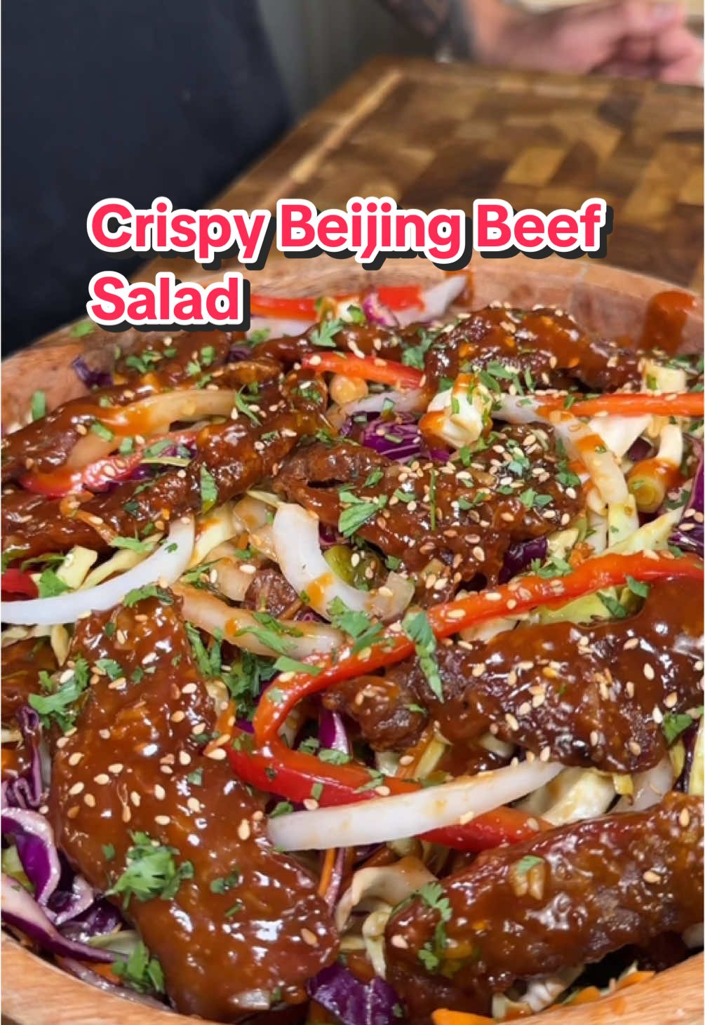 A post by @ice.karimcooks on TikTok caption: SAVE THIS ‼️ HEALTHIER Crispy Beijing Beef Salad 🤯 (recipe 👇🏽) EXQUISITE EATS IS OUT NOW!! My debut cookbook has 85+ delicious and healthy recipes to help you achieve your goals! Link in my bio 🙌🏼❤️ Macros per serving (makes x3): Approx. 734 Calories | 49g P | 67g C | 29g F Crispy Beijing beef: Top sirloin, 1.5 lbs cut into thin strips  Light soy sauce, 1 tbsp Egg white, 1 beaten Chili flakes, ¼ tsp Baking soda, 1 tsp Corn starch, 1 tbsp White pepper, 1 tsp Avocado oil spray  To dredge: 3/4 cup cornstarch For the salad: 1/2 cup Shredded Carrot 🥕  2 cups Cabbage (50/50 white & purple)  1 White onion, thinly sliced 1 red bell pepper, thinly sliced  Green onion Beijing beef sauce: 1 tbsp butter Garlic, 3-4 cloves finely minced  Ginger, 2 tsp grated Brown sugar, 3 tbsp  Water, ½ cup Oyster sauce, 3 tbsp Ketchup, 2 tbsp Sriracha, 3 tbsp Hoisin, ¼ cup Rice vinegar, 2tbsp Garnish: Red chili 🌶️  Sesame  Cilantro (optional) 🌿  Enjoy! 😍 . . . . #icekarim #healthyrecipes #easyrecipes #mealprep #quickrecipes 