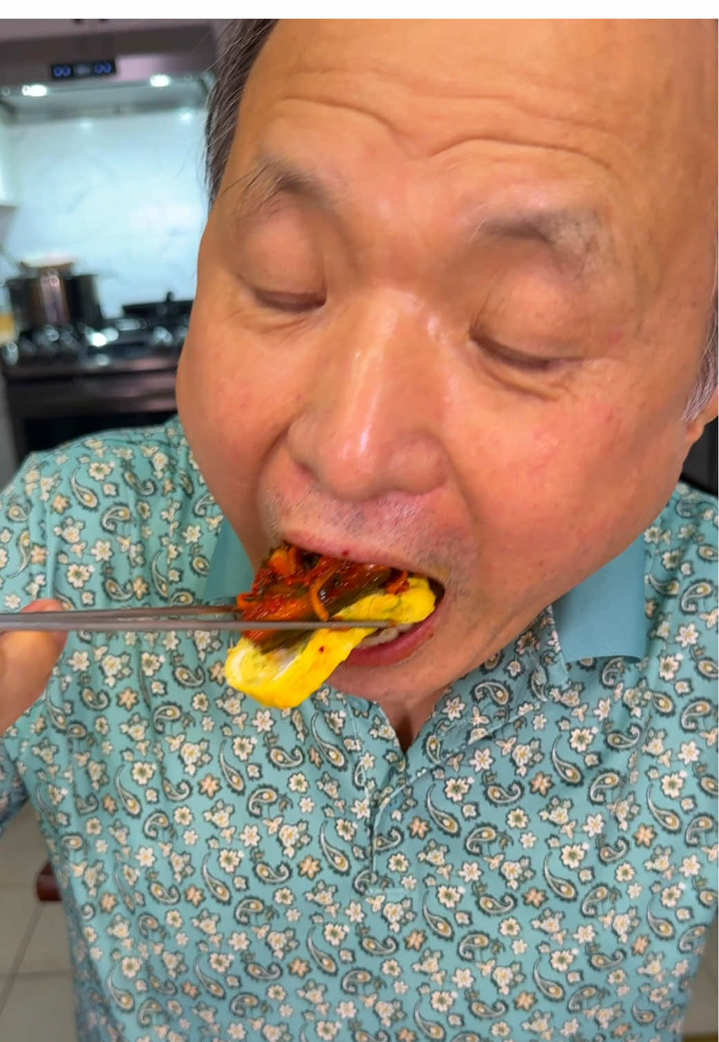 A post by @crazykoreancooking on TikTok caption: See how we made cucumber kimchi in previous video. It was time to taste our cucumber kimchi. Mom made my favorite miyeokguk (beef and seaweed soup) and I made my king gaeranmari (Korean rolled eggs).  #kimchi #cucumberkimchi #koreanfood #mukbang #kdrama 