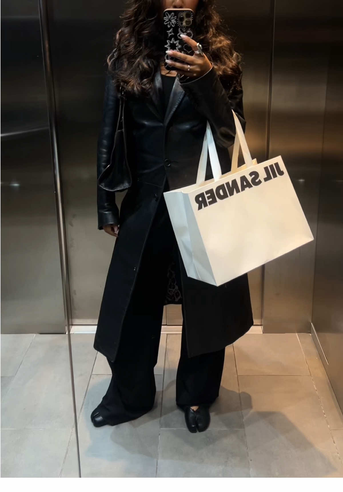 A post by @davinakareer on TikTok caption: all black makes my soul happy 🪐  #OOTD #dolceandgabanna #jilsander #vintedfinds #asos #zara #tabi #maisonmargiela #allblackoutfit @Vinted 