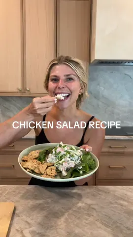 A post by @sydneyadamsking on TikTok caption: My current chicken salad recipe (I change it whenever I get sick of a recipe because there are a million variations you can do)  Shredded chicken in food processor  85g Greek yogurt  Dijon mustard  Dill seasoning  Salt Diced celery Pickles and some pickle juice  Pickled onion  Pumpkin seeds Green onion  Spring mix  & with Mary’s crackers! 