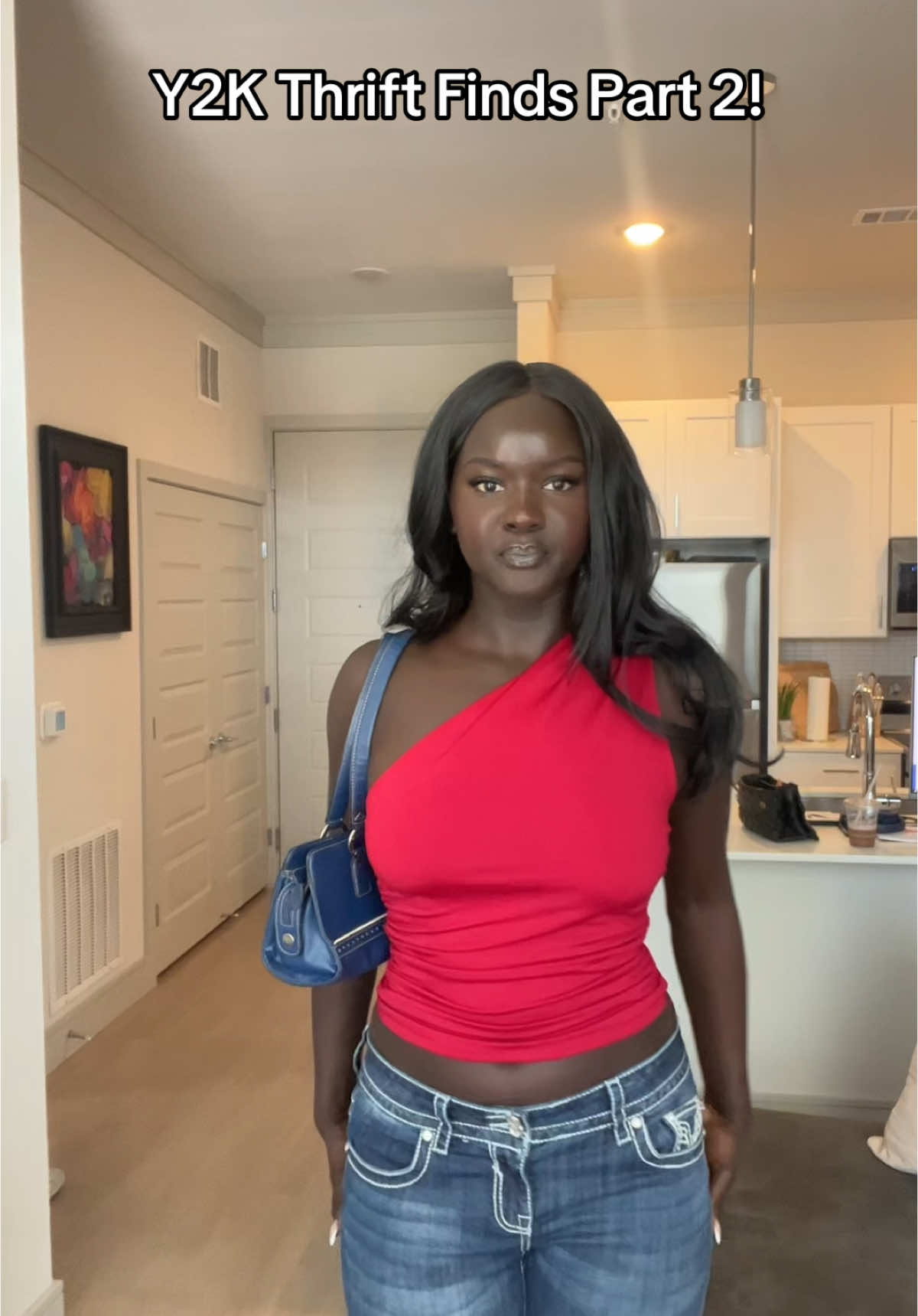A post by @missslado on TikTok caption: Obsessed with this purse and these capris!!  #thriftfinds #y2k #2000s #fashion 
