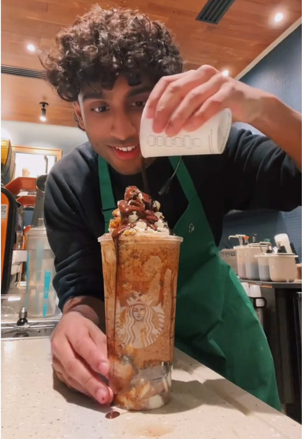 A post by @itsjoboi on TikTok caption: Caramel Cookie Frappuccino is a delicious drink at Starbucks!🔥 #fyp #viral #trend #starbucks #indian #barista #brown 