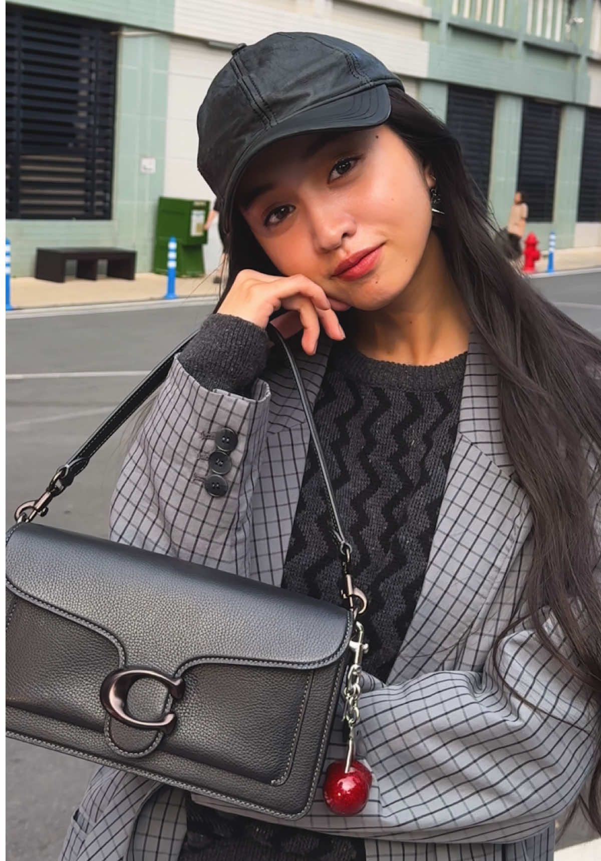 A post by @coach on TikTok caption: #koki, repping Coach head-to-toe✨ #CoachNY #CourageToBeReal #OOTD #fitcheck 