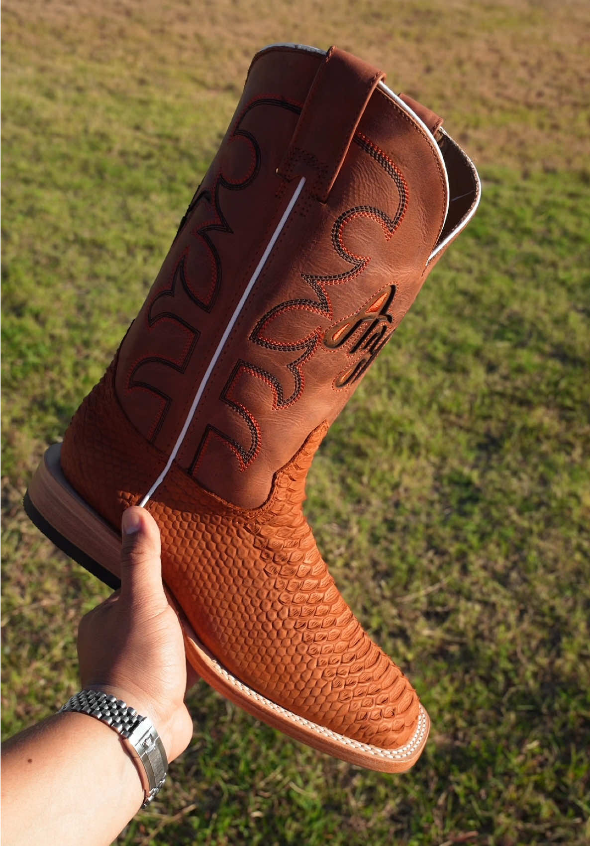 A post by @alfawesternwear on TikTok caption: Closer Look At Our Exclusive Matte Cognac Python Boots 🐍🔥 #alfawesternwear #alfawesternwearboots #python #texas #cowboyboots #westernwear #cowboyshit #botasvaqueras 