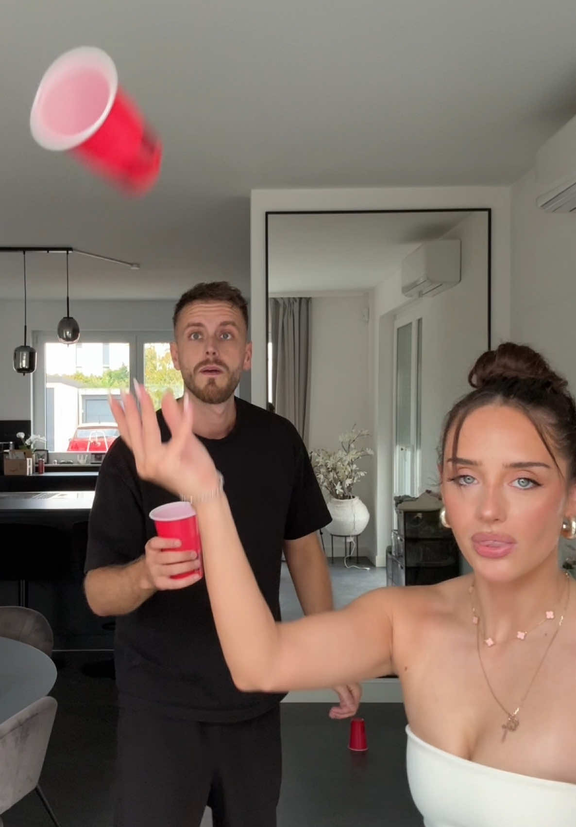 A post by @julienco on TikTok caption: Cup Challenge @palinamin 😂❤️
