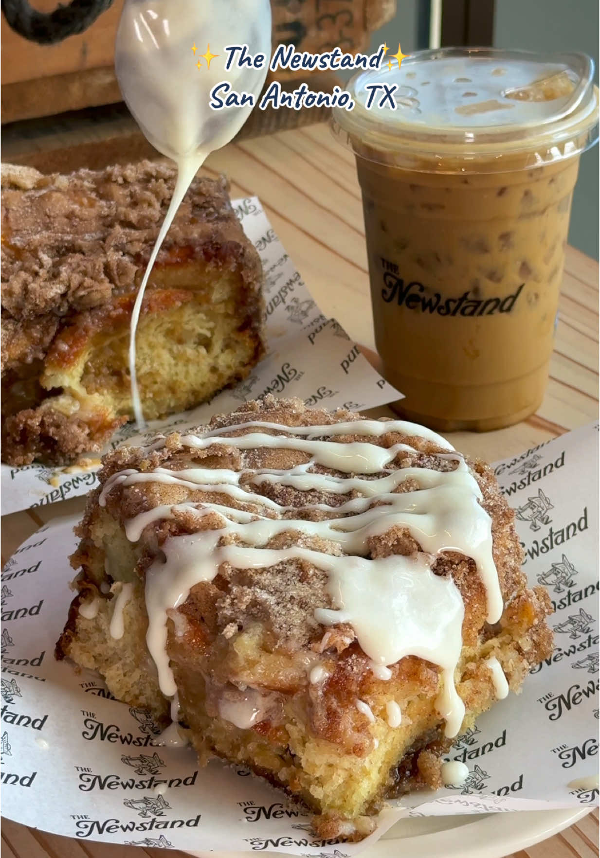 A post by @sanantoniofoodie on TikTok caption: One of the best cafés in San Antonio for unique coffee drinks, stacked sandwiches, and delicious pastries! 📍 @The Newstand - 1900 Broadway St Suite 106 ⏰ Open daily from 7am–7pm #sanantonio #sanantoniotx #sanantoniofoodie #satx #tiktoksanantonio #sanantoniocheck 