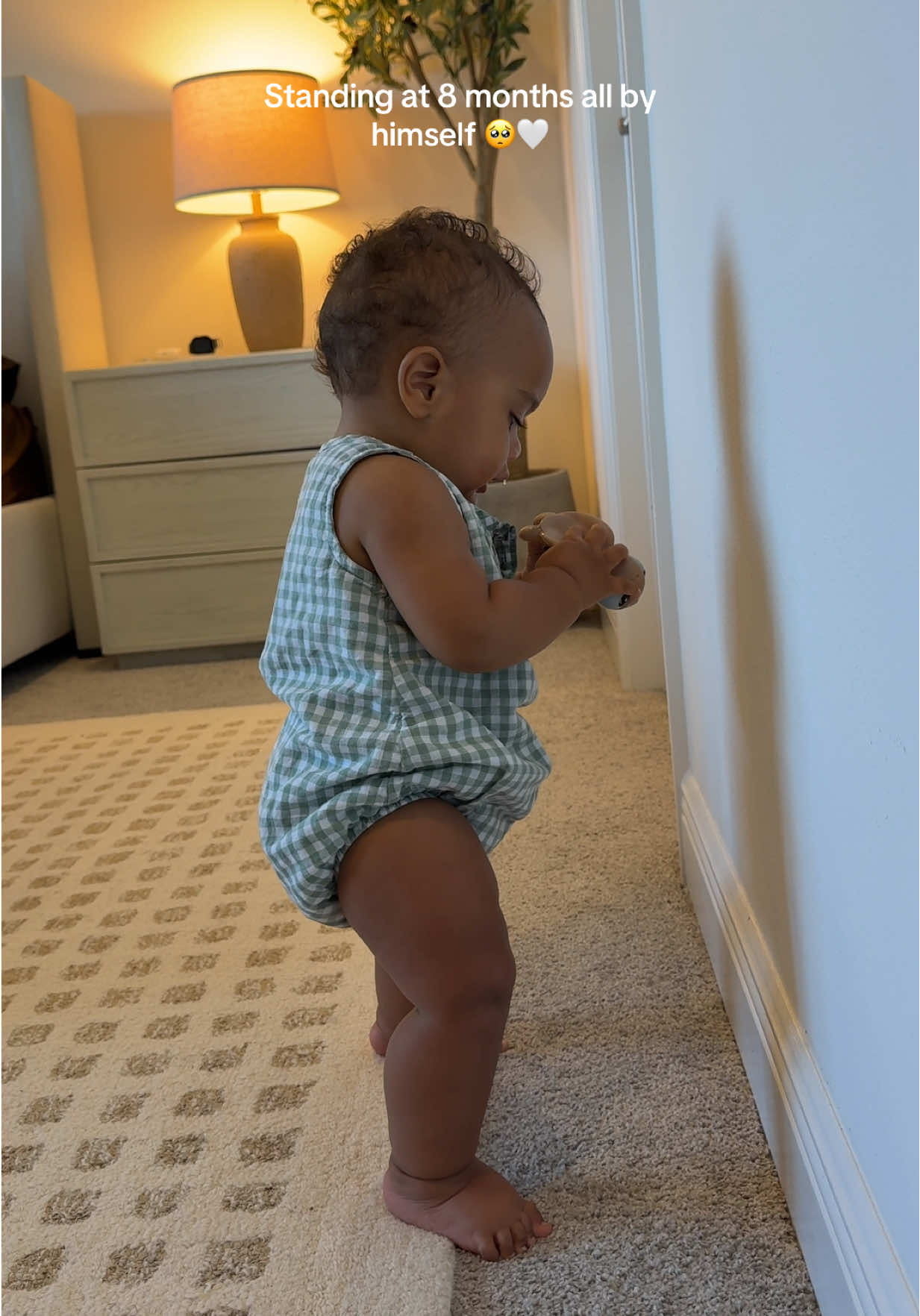 A post by @ on TikTok caption: I’m not okay if yall are wondering 🥲 he started standing on stuff at 7 months but now he’s legit ready to walk #baby 