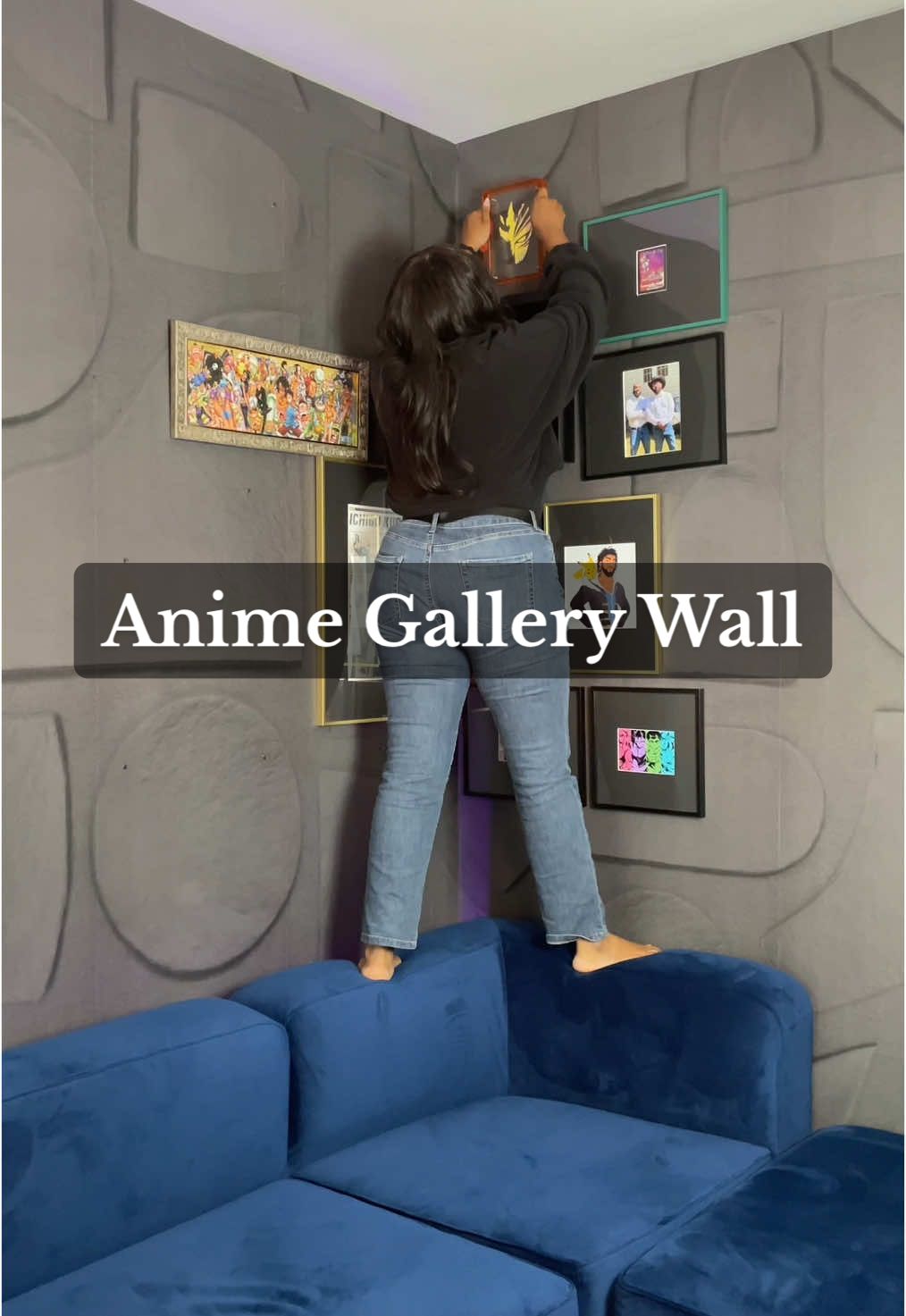 A post by @myuglyapartment on TikTok caption: Shop this gallery wall in my bio!  #animedecor #animegallerywall #atlantainteriordesigner #goku #bleachanime #onepiece #yuyuhakusho #bluesofa #rebelwallswallpaper #mancaveideas #mancavedecor #cozyapartment #apartmentdecor 
