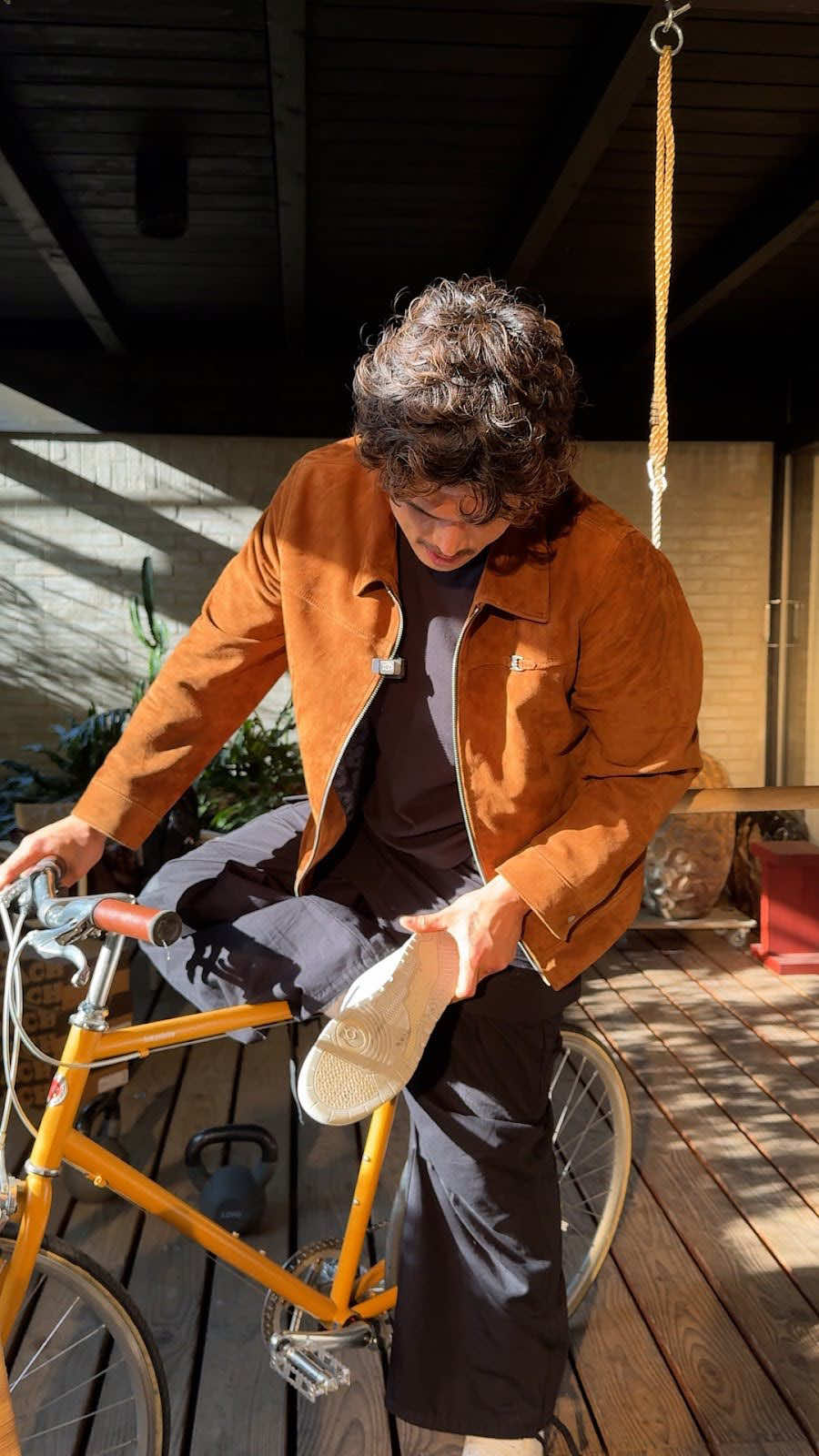 A post by @coach on TikTok caption: Getting to the heart & “sole” of NYC w/ Charles Melton ❤️🗽 #CoachNY #CharlesMelton #SohoSneaker #EasterEgg #Sneakers #SneakerInspo #MensFashion